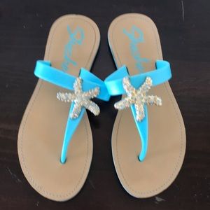 Teal Skechers sandals with star fish
